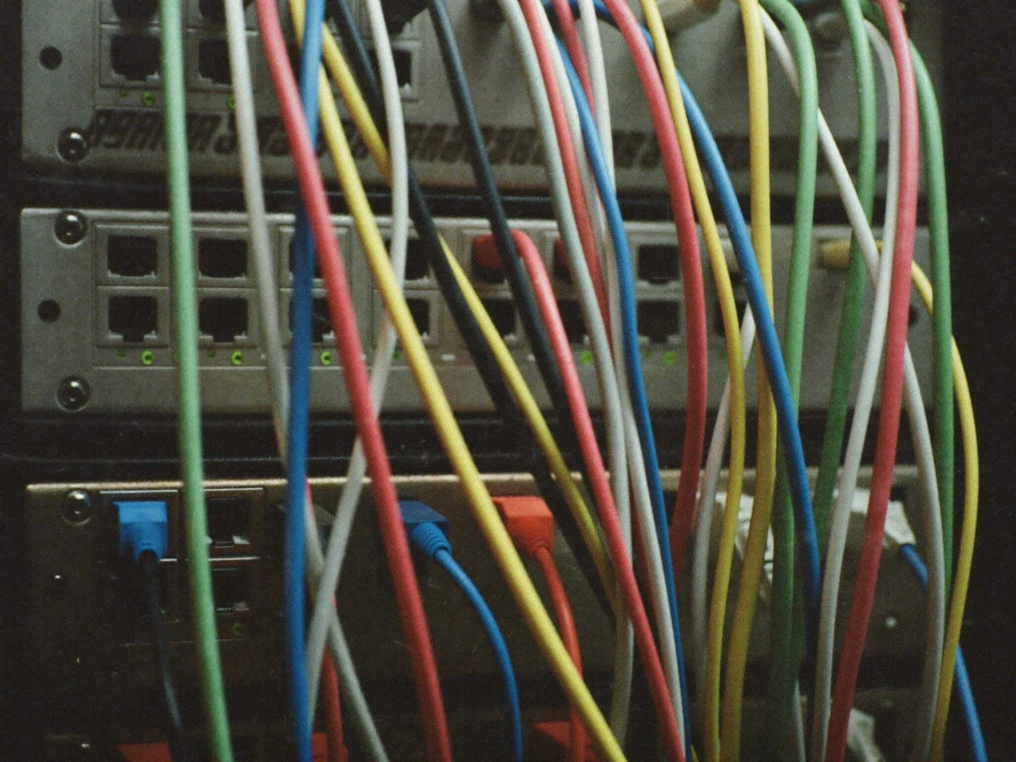 Colour-coded cables in a network patch panel